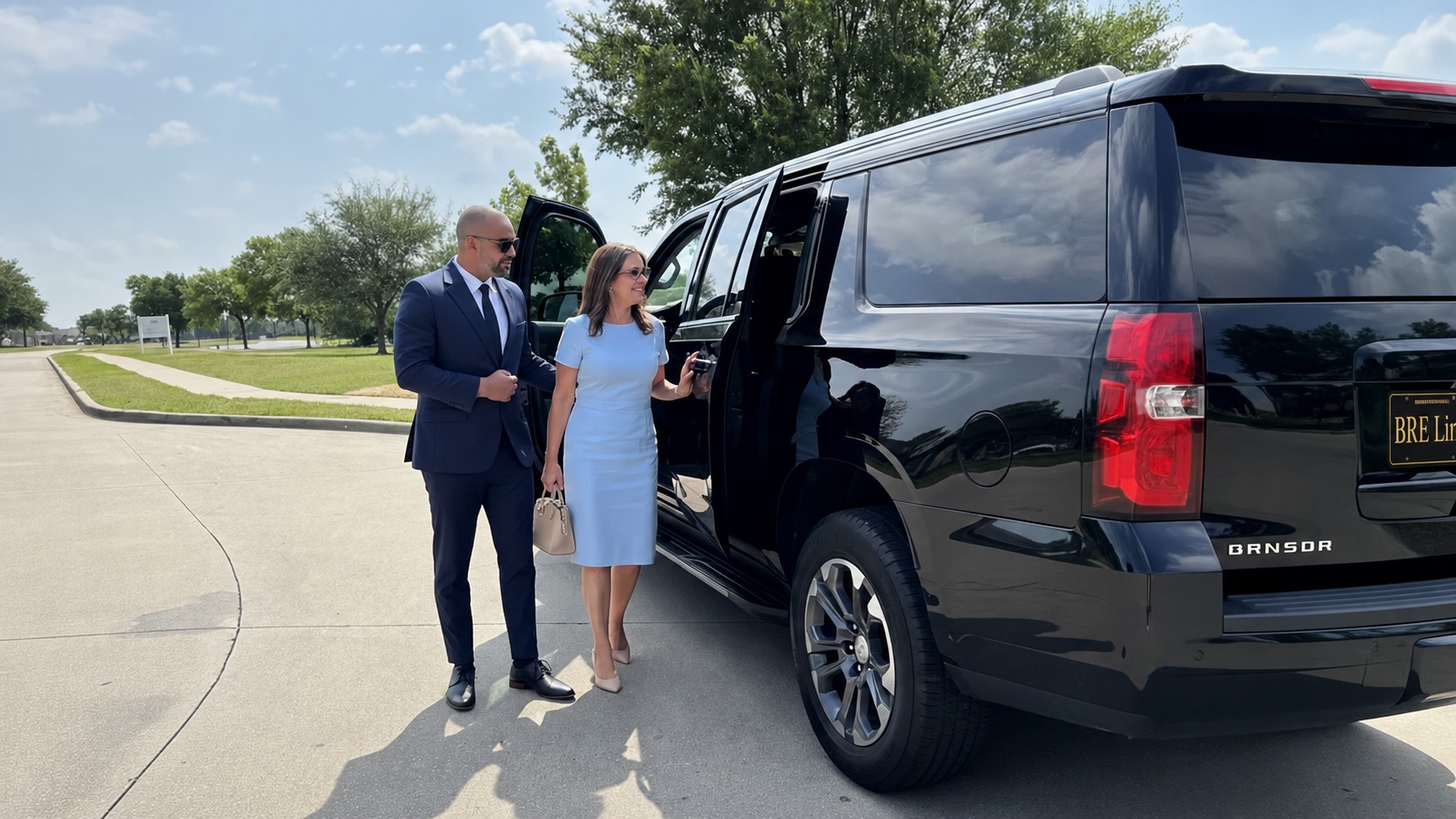 BRE Limo chauffeur assisting a passenger beside a black SUV